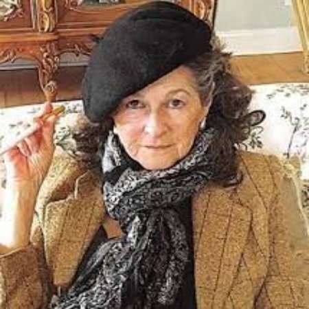 Molly Ann Cooke was wearing a cap, sweater and black scaff.